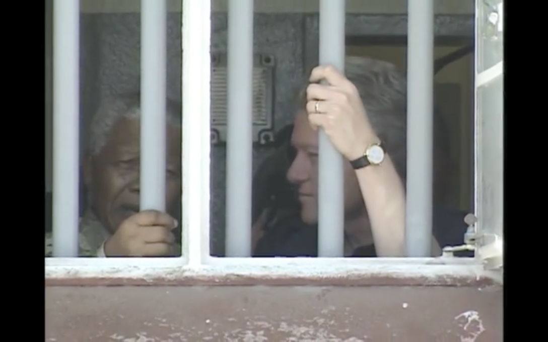 Nelson Mandela shows Bill Clinton his Prison Cell