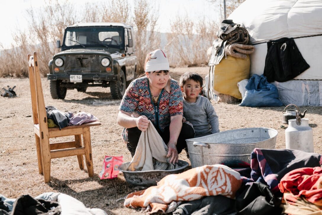 Woman with child washing clothes